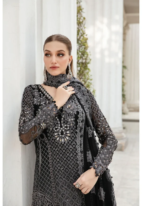 Luxury formal wear in black with silver embellishments, featuring a long maxi dress and a sheer dupatta.