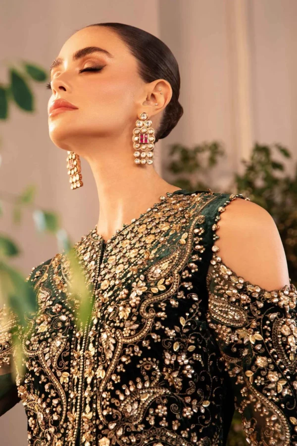 An exquisite dark green designer ensemble featuring handcrafted zardozi, beadwork, and traditional motifs, perfect for wedding celebrations and evening glamour.