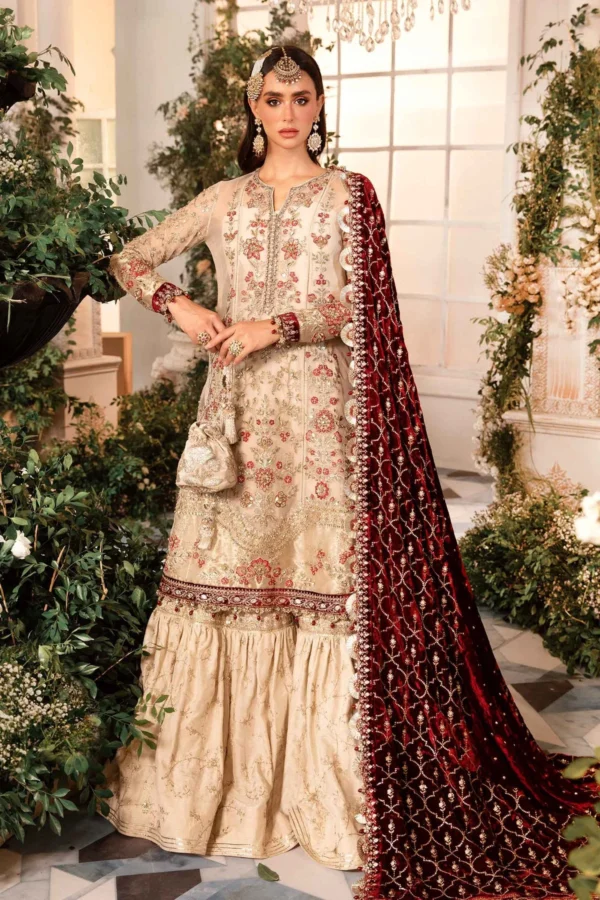 "Luxury Pakistani Bridal Dress – An elegant beige and red wedding outfit with intricate embroidery, a velvet dupatta, and exquisite craftsmanship."