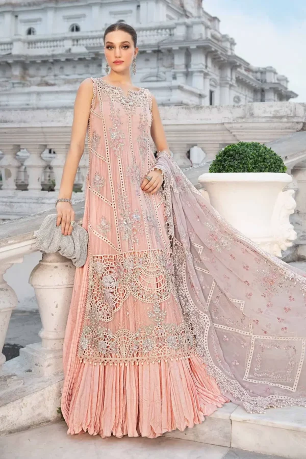 Elegant pastel pink designer dress with intricate embroidery and lace detailing.