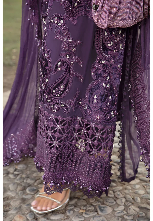 A regal deep violet designer outfit adorned with handcrafted embroidery, delicate beadwork, and a statement dupatta.