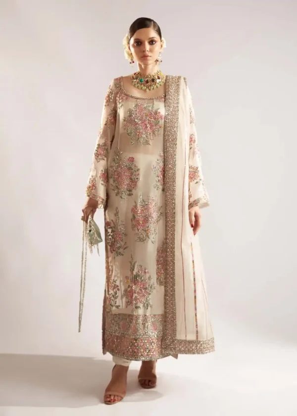 Elegant embroidered Pakistani formal wear in soft beige with floral embellishments and hand-sewn details