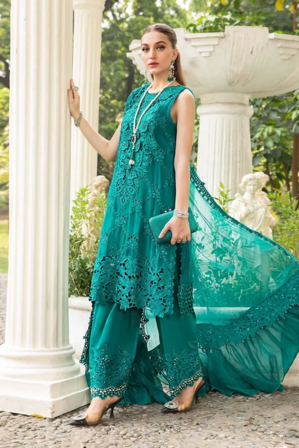 "Chic and stylish teal designer suit featuring delicate cutwork, embellishments, and trendy straight trousers."