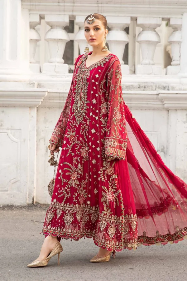 "Royal maroon bridal wear featuring heavy embellishments, zari embroidery, and statement jewelry for a glamorous wedding look."