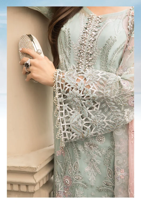 "Luxury designer embroidered chiffon outfit in mint green with delicate pastel pink floral handwork, perfect for wedding guests and festive occasions."