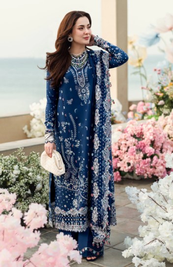 A fashionable long kurta with detailed white and pink embroidery, paired with trousers and a matching dupatta.