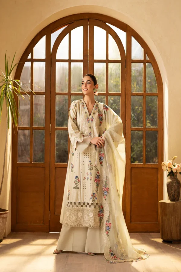 Woman wearing a soft beige floral embroidered dress with delicate details