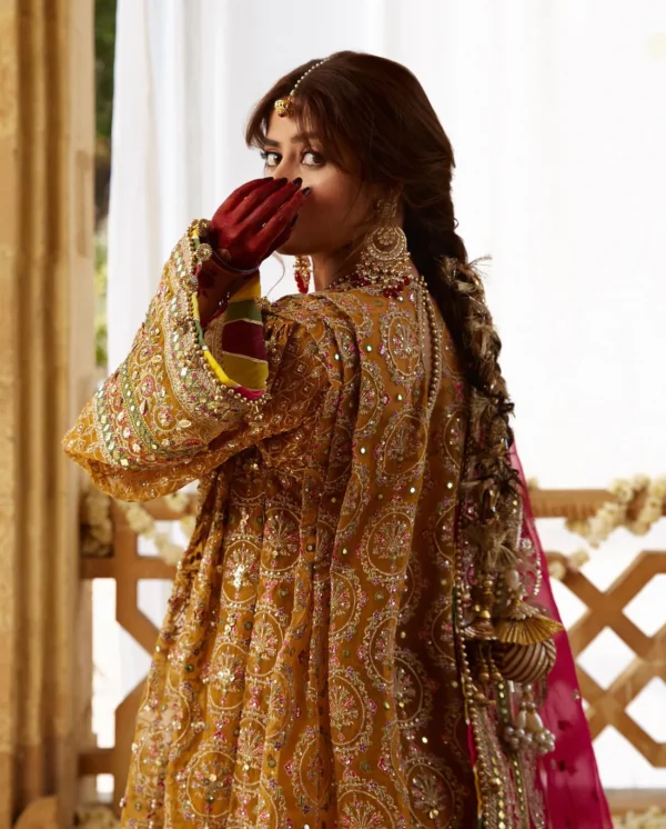Elegant yellow wedding dress with modern cuts and traditional embroidery.