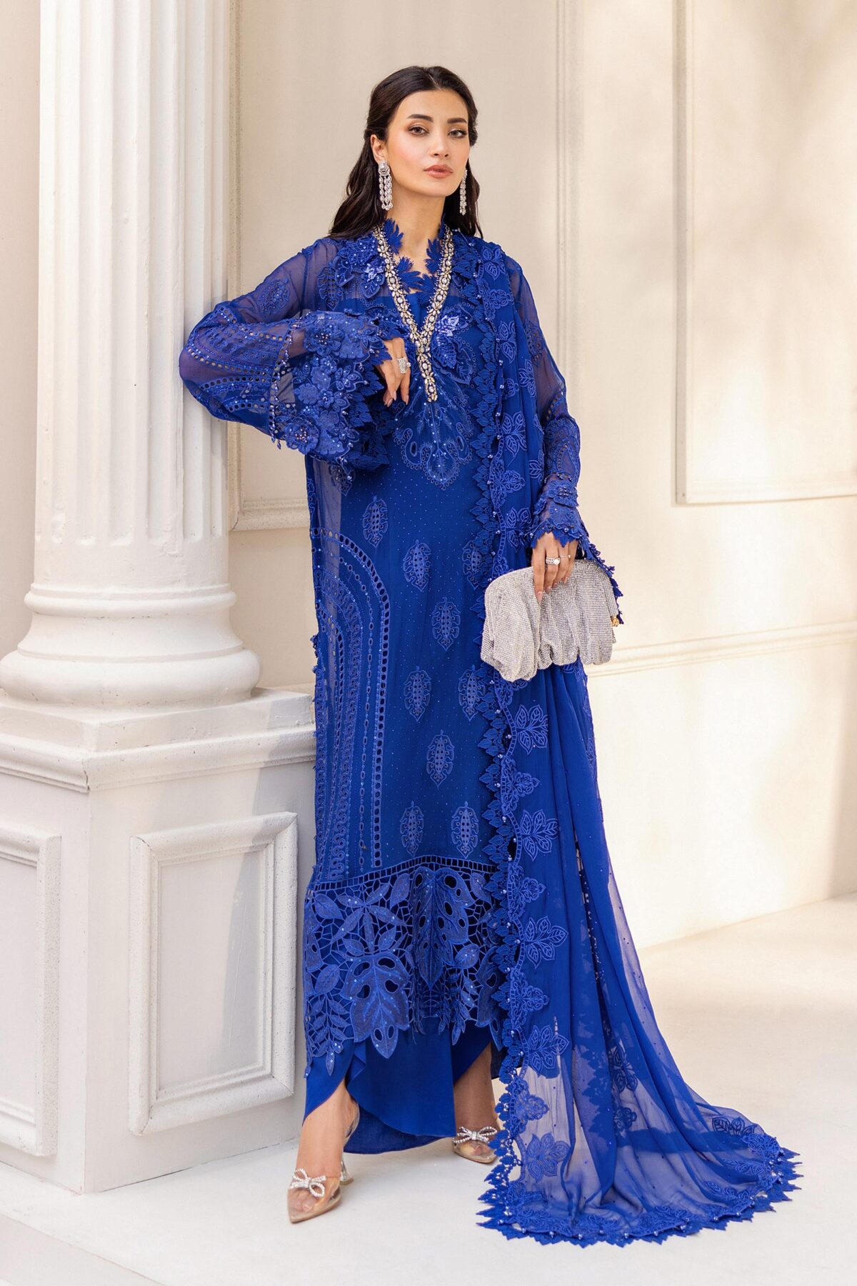 legant blue outfit from Maria B Chiffon Collection with delicate embroidery and premium fabric.