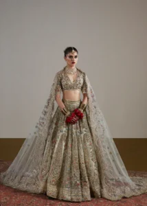 A detailed shot of a bride's red and gold lehenga with intricate lehenga designs, heavy embroidery, and traditional motifs.