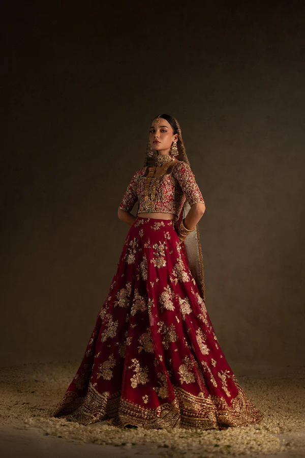 Red bridal dress embellished with golden embroidery and coordinating dupatta
