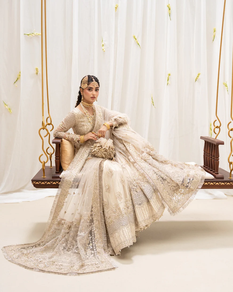 Nikah and Walima Bridal Gharara | Gold Styling Bride styled with gold jewellery and potli in bridal gharara online Pakistan
